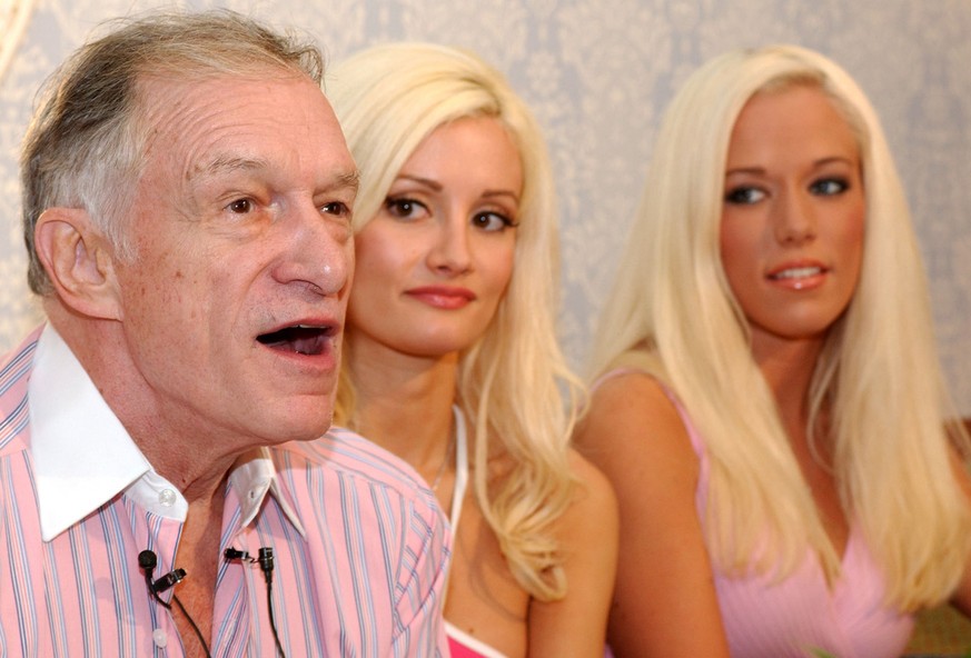 Playboy magazine founder Hugh Hefner, left, answers questions during a news conference at Walt Disney World in Lake Buena Vista, Fla., Thursday, Feb. 3, 2005. Shown here with Hefner are Holly Madison, ...