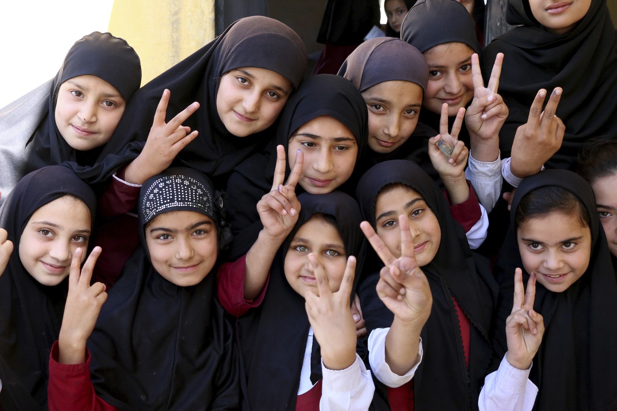 Students of the school of Nobel Peace Prize winner Malala Yousafzai flash victory sign in her hometown of Swat Valley in Pakistan, Friday, March 30, 2018. A Pakistani women's activist says Malala ...
