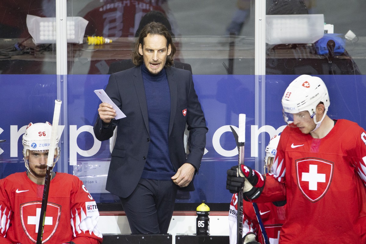 Patrick Fischer, head coach of Switzerland national ice hockey team, talks between Switzerland's forward Noah Rod, let, and Switzerland's forward Joel Vermin, right, during the IIHF 2021 Wor ...