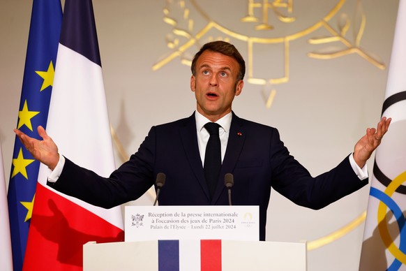 epa11491638 French President Emmanuel Macron gestures and reacts as he delivers a speech during a reception for international journalists accredited for the Paris 2024 Olympic Games, at the Elysee Pre ...
