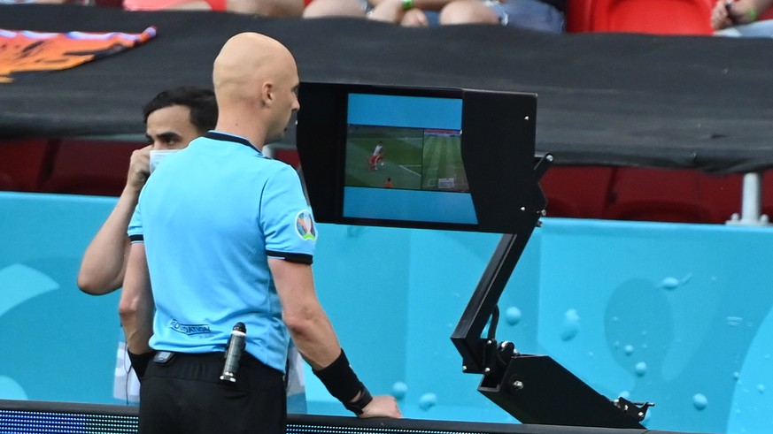 epa09305851 Russian referee Sergei Karasev looks at a replay of the video assistant referee (VAR) system during the UEFA EURO 2020 round of 16 soccer match between the Netherlands and the Czech Republ ...