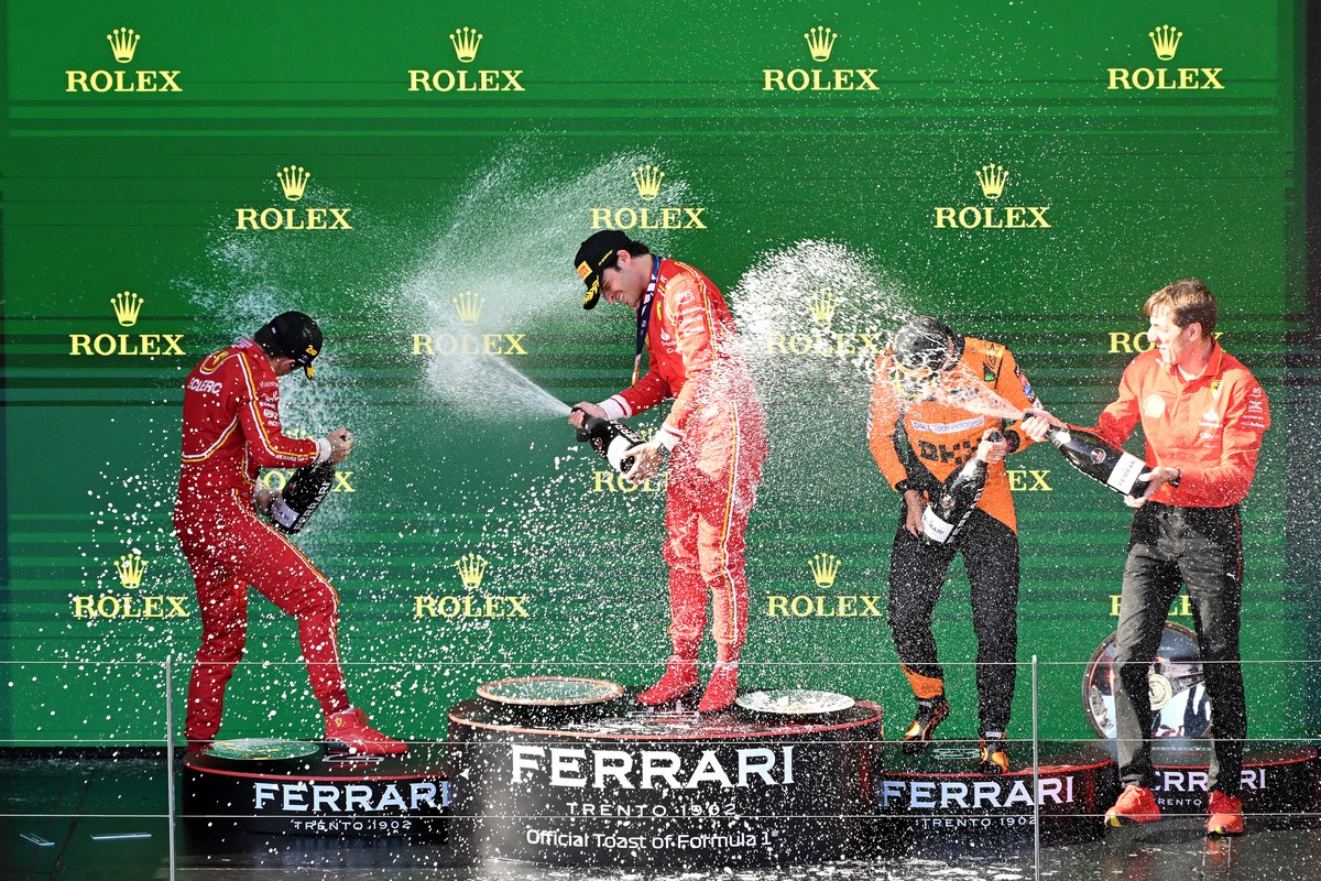 epa11240561 (L-R) Second-placed Ferrari's Charles Leclerc of Monaco, first-placed Carlos Sainz of Spain, third-placed McLaren's Lando Norris of Britain, and Ferrari engineer Mateo Togninalli ...