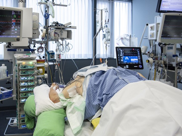 Pflegepersonal im Universitaetspital der Insel Gruppe kuemmern sich auf der Intensivstation um einen Covid Patienten , am Mittwoch, 16. Dezember 2020, in Bern. (KEYSTONE/Peter Schneider)