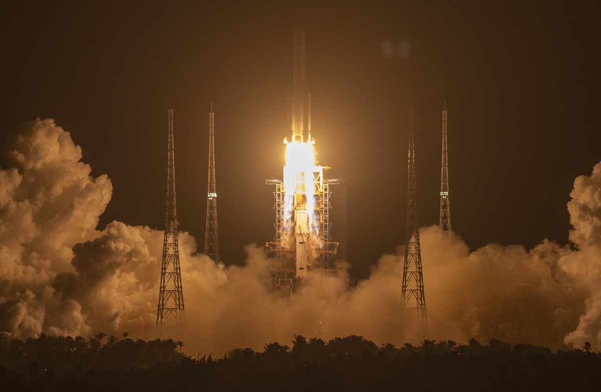 A Long March-5 rocket carrying the Chang'e 5 lunar mission lifts off at the Wenchang Space Launch Center in Wenchang in southern China's Hainan Province, early Tuesday, Nov. 24, 2020. China  ...