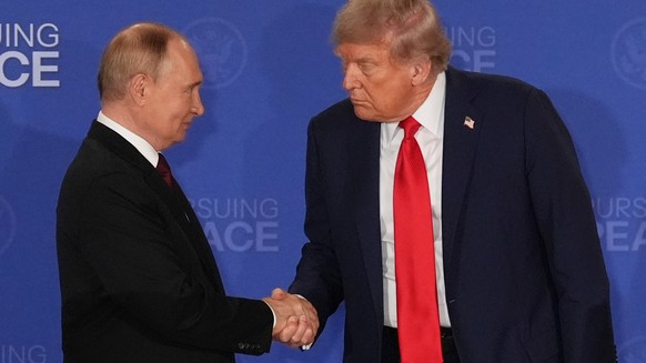 FILE - President Donald Trump, right, shakes the hand of Russia's President Vladimir Putin during a joint press conference at Joint Base Elmendorf-Richardson, Alaska, Aug. 15, 2025. (AP Photo/Jae ...