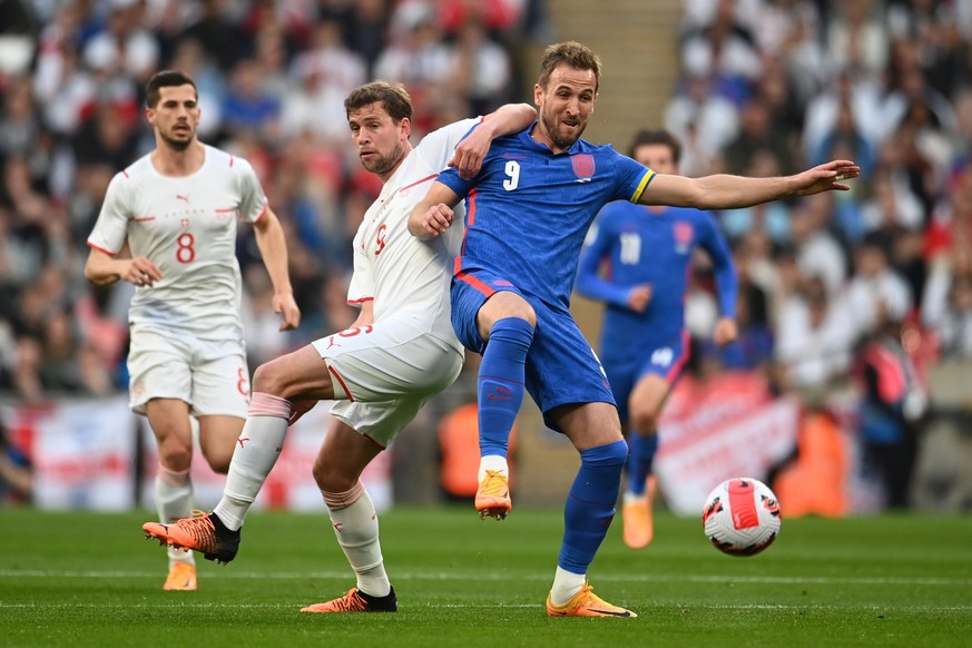 epa09851450 England&#039;s Harry Kane (R) in action against Switzerland&#039;s Fabian Frei (L) during the International friendly soccer match England vs Switzerland at Wembley Stadium, London, Britain ...