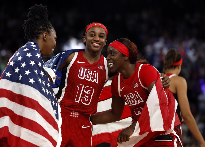 epa11545703 USA players celebrate after winning the Women Gold Medal game between France and USA of the Basketball competitions in the Paris 2024 Olympic Games, at the South Paris Arena in Paris, Fran ...