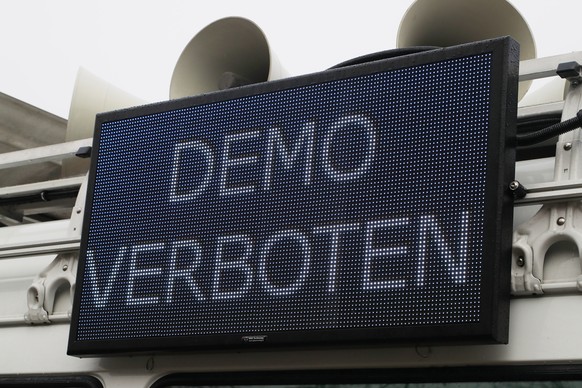 epa08863322 A sign reading ÄöDemo prohibitedÄò is seen on a police car at the Buergerweide square in Bremen, northern Germany, 05 December 2020. Activists of the Querdenken movement announced two de ...