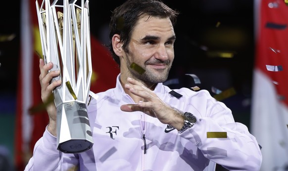 Roger Federer of Switzerland celebrates with his winner trophy after defeating Rafael Nadal of Spain in the men&#039;s singles final match of the Shanghai Masters tennis tournament at Qizhong Forest S ...