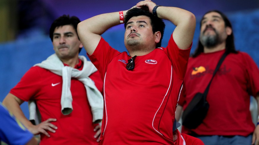 epa06258087 Chilean fans react after losing against Brazil at the end of the FIFA World Cup CONMEBOL 2018 qualifier match between Brazil and Chile at the Allianz Park in Sao Paulo, Brazil, 10 October  ...