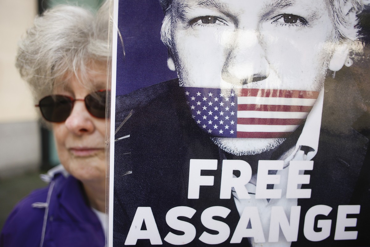 An activist marking five years since the arrest of Wikileaks founder Julian Assange demonstrates outside Westminster Magistrates' Court in London, Sunday, April 14, 2024. U.S. President Joe Biden ...