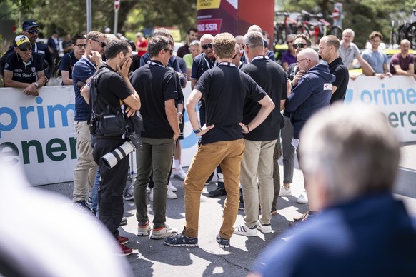 The Tour&#039;s organising committee members in discussion, after they learned about the passing of racer Gino Maeder from Switzerland of Bahrain-Victorious, who crashed the day before, at the 86th To ...