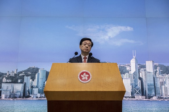 FILE – Hong Kong Chief Executive John Lee speaks at a press conference in Hong Kong, March 21, 2023. Lee said on Tuesday, July 4, that eight pro-democracy activists now living in the United States,…