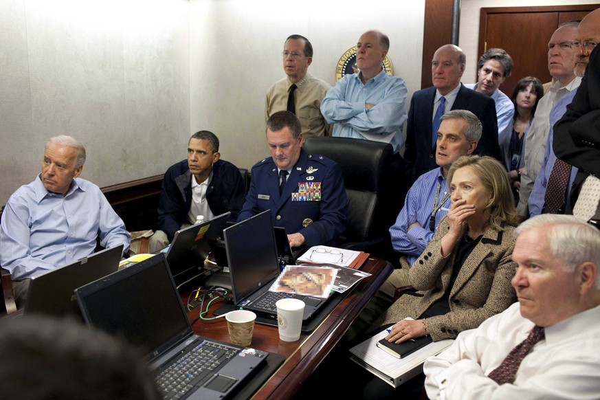 FILE -In this May 1, 2011 file image released by the White House and digitally altered by the source to diffuse the paper in front of Secretary of State Hillary Clinton, President Barack Obama and Vic ...