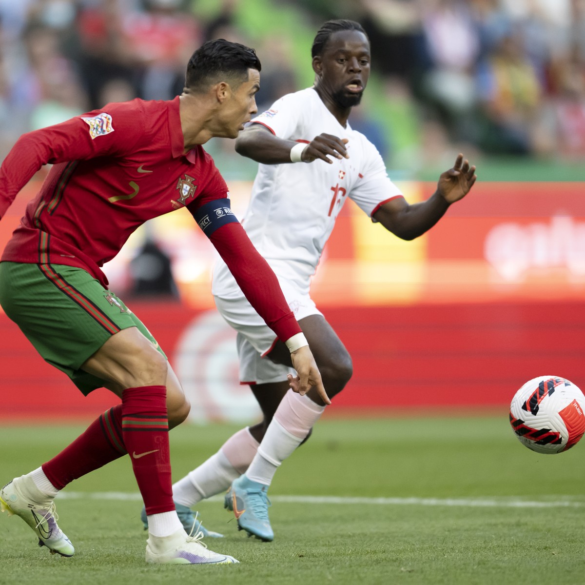 epa09998044 Portugal's Cristiano Ronaldo (L) in action against Switzerland's Jordan Lotomba (R) during the UEFA Nations League soccer match between Portugal and Switzerland in Lisbon, Portug ...