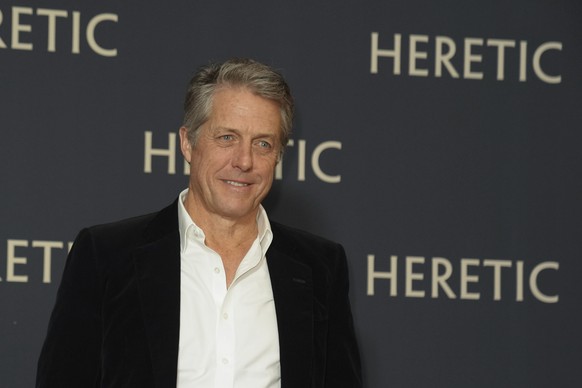 British actor Hugh Grant poses as he arrives at the France premiere of Heretic, in Paris, Tuesday, Nov. 19, 2024. (AP Photo/Thibault Camus)
