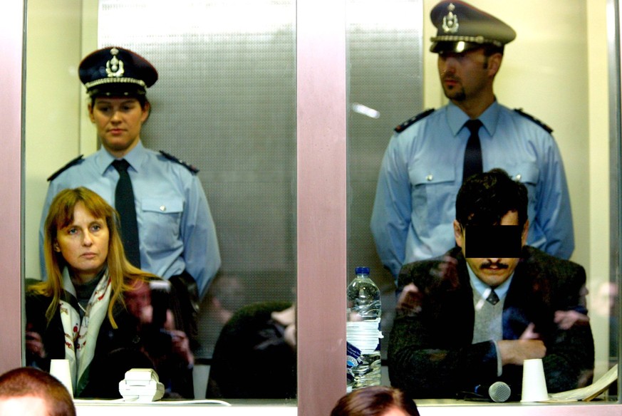 BRU117 - - ARLON, BELGIUM: Marc Dutroux (R) and his former wife Michelle Martin (L) sit inside the accused s box on the first day of their trial, Monday 01 March 2004, at the Arlon assize court. Alleg ...