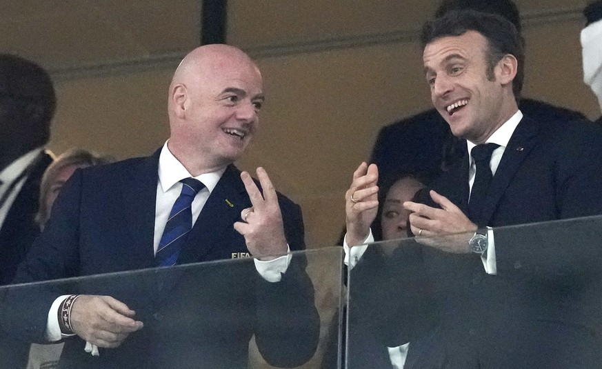 FIFA President Gianni Infantino, left, talks to French President Emmanuel Macron prior to the World Cup final soccer match between Argentina and France at the Lusail Stadium in Lusail, Qatar, Sunday,  ...