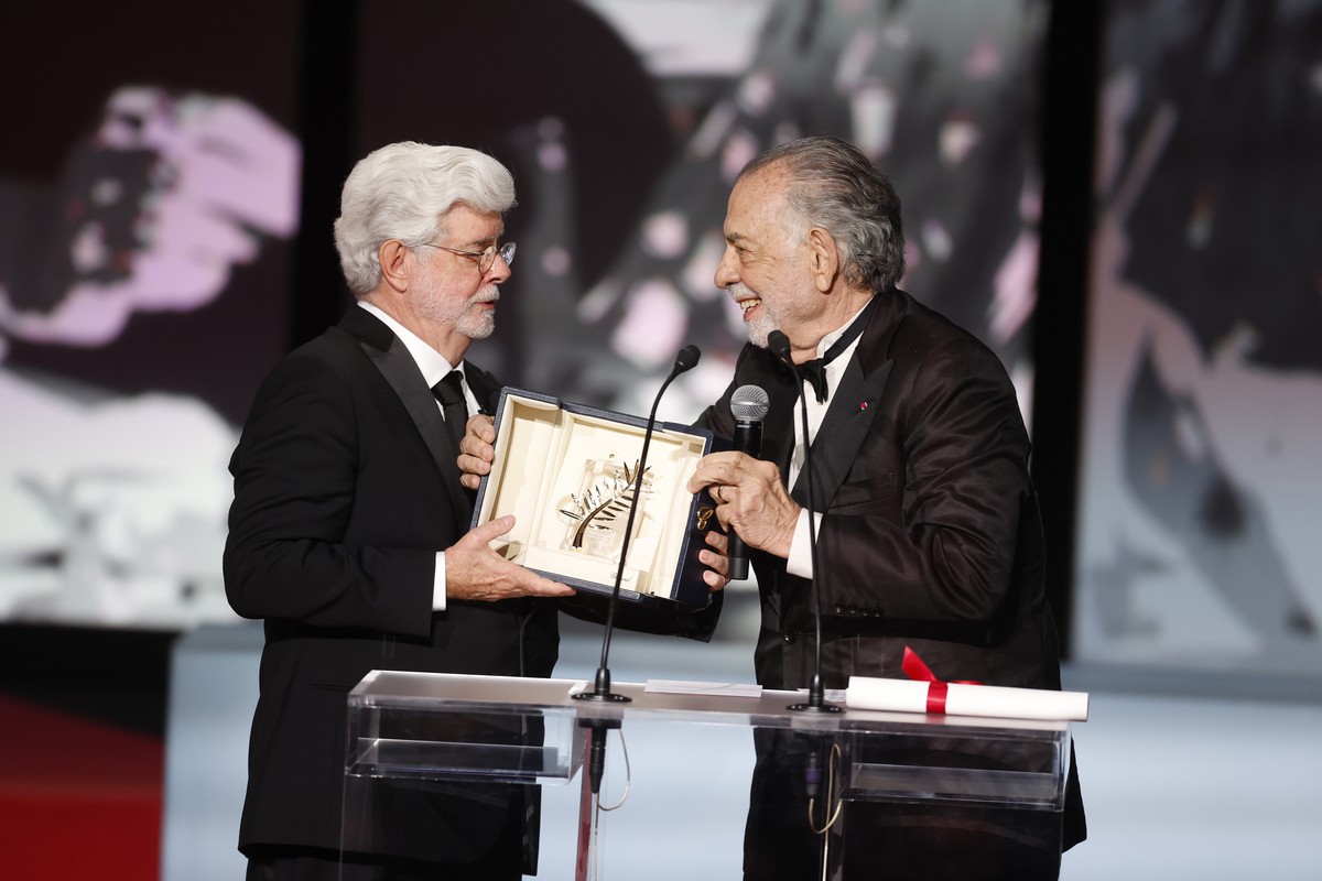 epa11370048 George Lucas (L) accepts the Honorary Palme D'Or Award from Francis Ford Coppola (R) during the closing and awards ceremony of the 77th annual Cannes Film Festival, in Cannes, France, ...