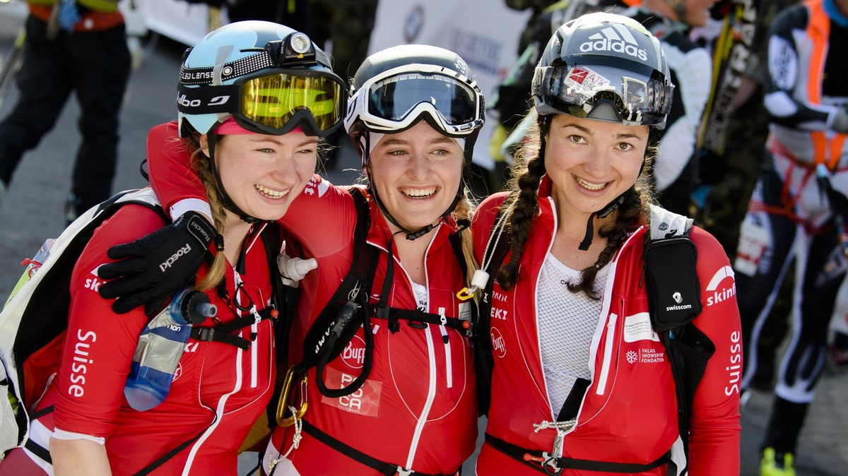 Marianne Fatton, left, Florence Buchs, center, and Deborah Chiarello, right, Patrol "Swiss Team Espoir" from Switzerland celebrate after crossing the finish line during the 21st Glacier Patr ...