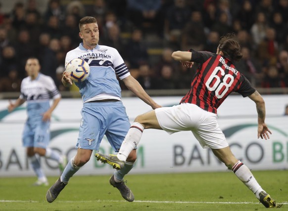 Lazio&#039;s Sergej Milinkovic Savic, left, and AC Milan&#039;s Ricardo Rodriguez challenge for the ball during the Serie A soccer match between AC Milan and Lazio, at the San Siro stadium in Milan, I ...