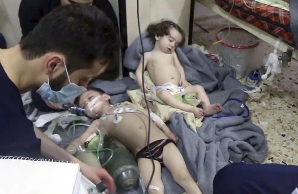 This image made from video released by the Syrian Civil Defense White Helmets, which has been authenticated based on its contents and other AP reporting, shows medical workers treating toddlers follow ...