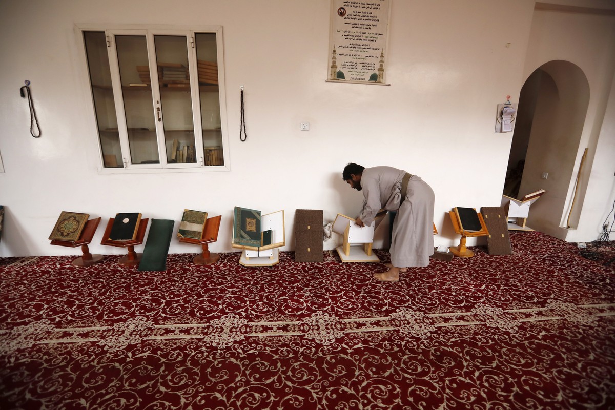 epa10521203 A man cleans a mosque in preparation for the Muslim holy month of Ramadan in Sana'a, Yemen, 13 March 2023. Yemenis began cleaning the mosques as part of the celebration of the holy mo ...