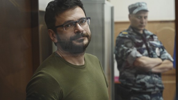 Russian opposition activist and a municipal deputy of the Krasnoselsky district Ilya Yashin stands in a cage at a court room during a hearing on his detention the Basmanny district court in Moscow, Ru ...
