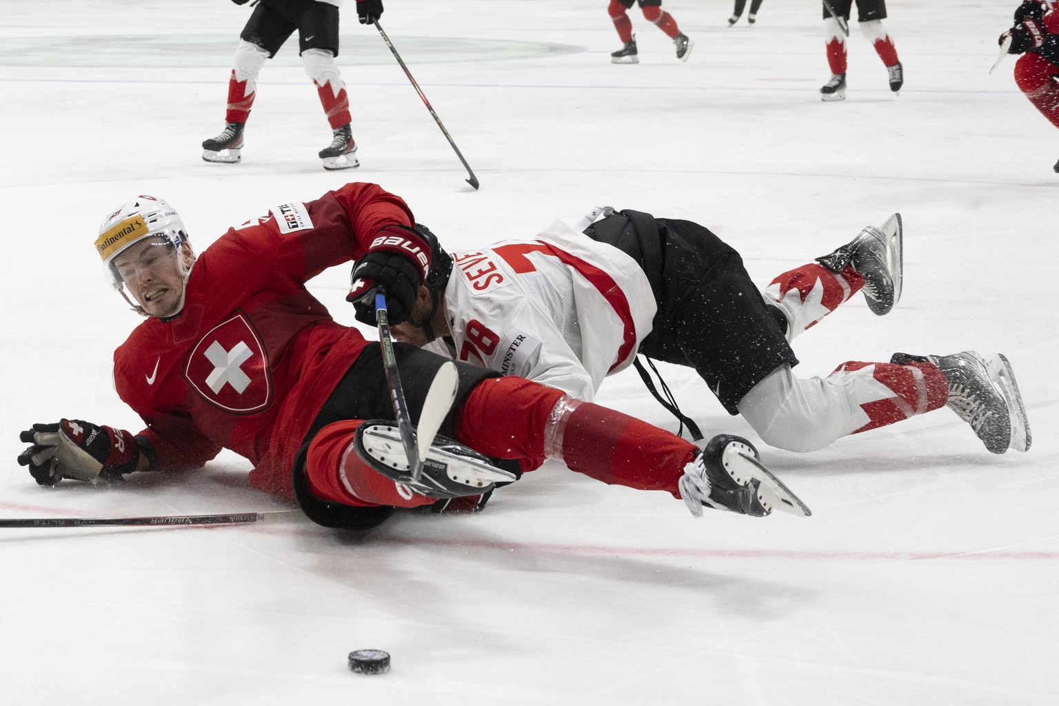 Switzerland&#039;s Dario Simion, left, in action against Canada?s Damon Severson during the Ice Hockey World Championship semi final match between Switzerland and Canada in Prague at the O2 Arena, Cze ...