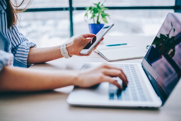 Smartphone/mobile phone next to the laptop