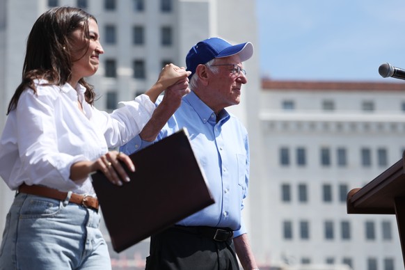 epa12028298 US Senator Bernie Sanders (L) and US Representative Alexandria Ocasio-Cortez stand together on stage during the &#039;Fighting Oligarchy Tour&#039; rally at Grand Park in Los Angeles, Cali ...