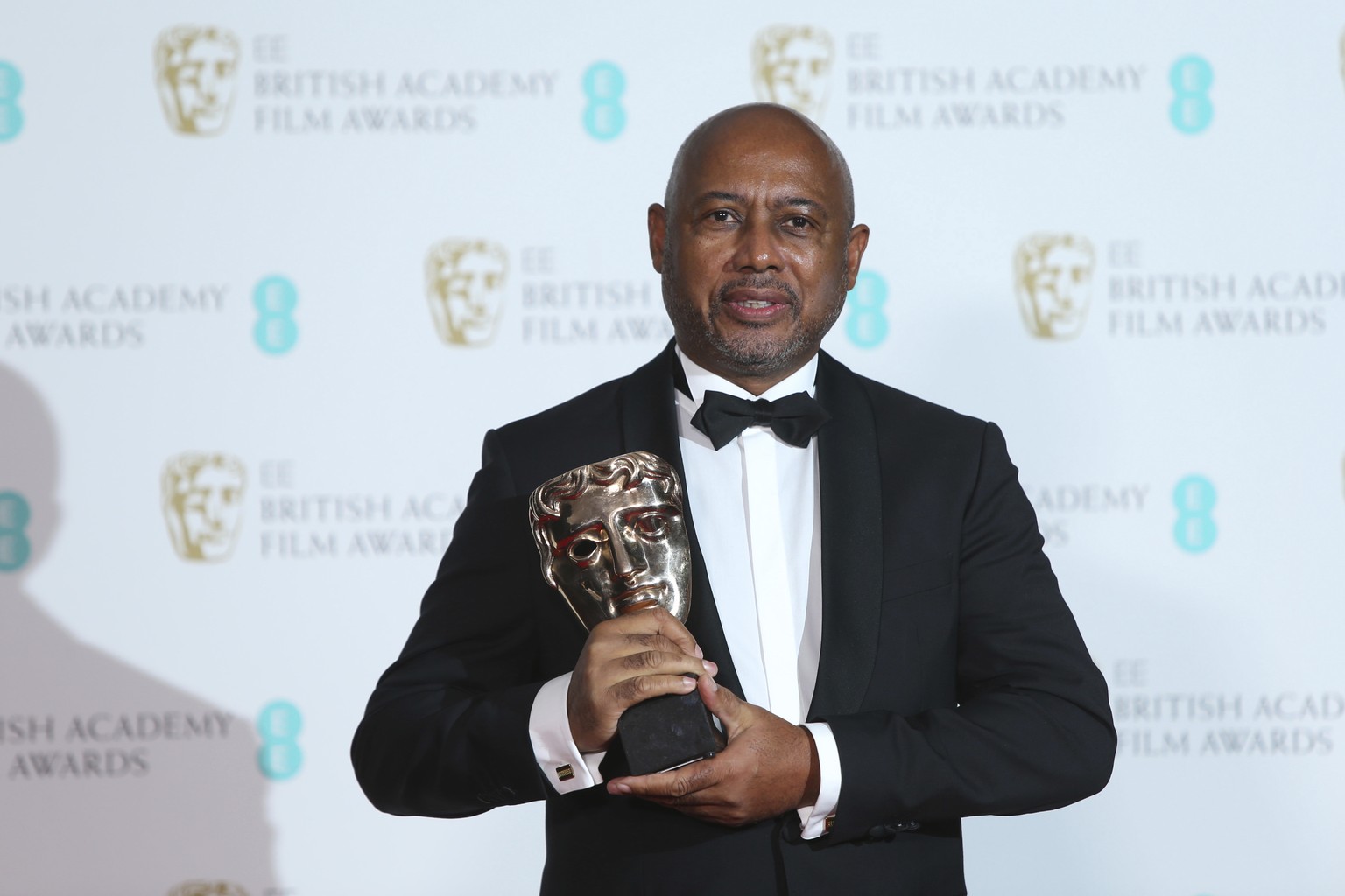 Filmmaker Raoul Peck holds his award for Best Documentary for &#039;I Am Not Your Negro&#039; backstage at the BAFTA 2018 Awards in London, Sunday, Feb. 18, 2018. (Photo by Joel C Ryan/Invision/AP)