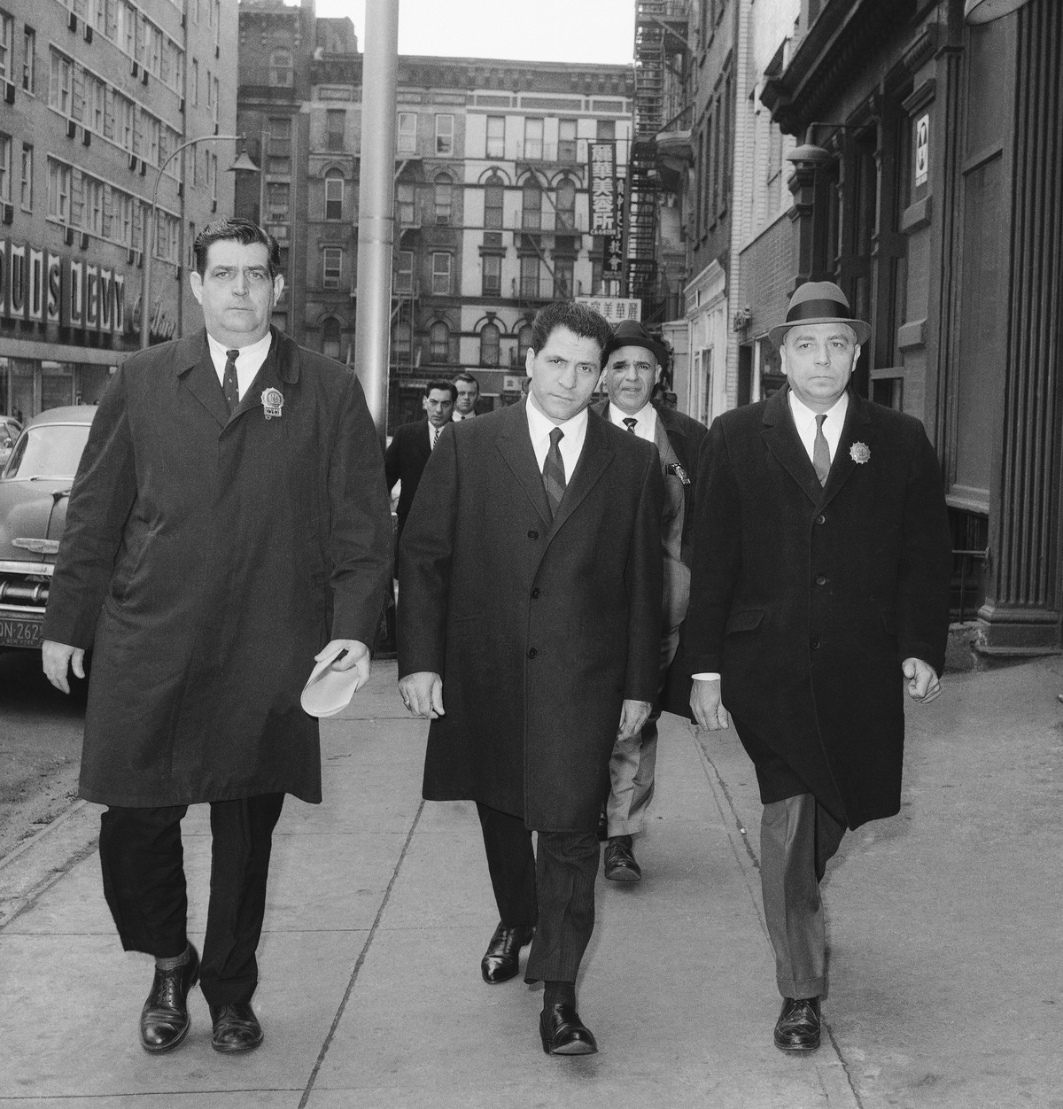 In this March 24, 1966, file photo, John "Sonny" Franzese, center, is escorted to the Elizabeth Street police station in New York, after his arrest on a 43-count gambling indictment. Franzes ...