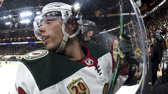 Minnesota Wild left wing Kevin Fiala (22) is checked against the glass by a Vegas Golden Knights player during the third period of Game 2 of a first-round NHL hockey playoff series Tuesday, May 18, 20 ...