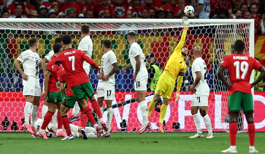 epa11451013 Cristiano Ronaldo of Portugal (CL) takes a free kick during the UEFA EURO 2024 Round of 16 soccer match between Portugal and Slovenia, in Frankfurt Main, Germany, 01 July 2024. EPA/ANNA SZ ...