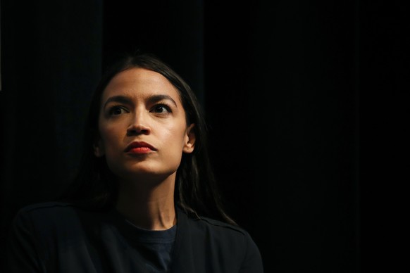 New York congressional candidate Alexandria Ocasio-Cortez listens to a speaker at a fundraiser Thursday, Aug. 2, 2018, in Los Angeles. The 28-year-old startled the party when she defeated 10-term U.S. ...