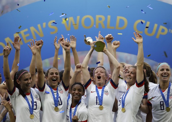 FILE - United States&#039; Megan Rapinoe lifts up a trophy after winning the Women&#039;s World Cup final soccer match between U.S. and The Netherlands at the Stade de Lyon in Decines, outside Lyon, F ...