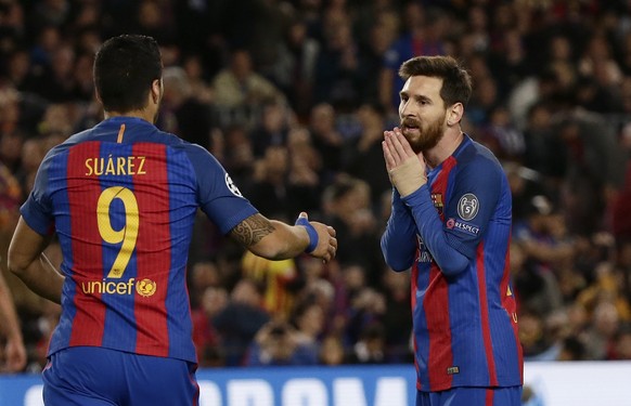 Barcelona&#039;s Luis Suarez, left, and Barcelona&#039;s Lionel Messi react after a missed chance to score during the Champions League quarterfinal second leg soccer match between Barcelona and Juvent ...