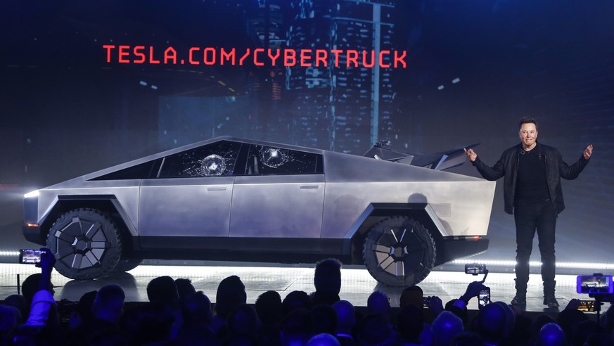 Tesla CEO Elon Musk introduces the Cybertruck at Tesla's design studio Thursday, Nov. 21, 2019, in Hawthorne, Calif. Musk is taking on the workhorse heavy pickup truck market with his latest electric  ...