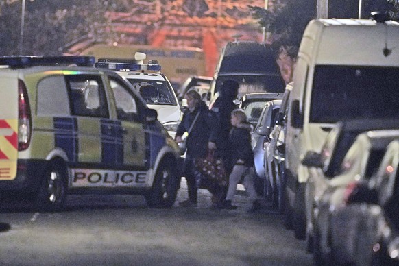 Police evacuate local residents during an incident at an address in Rutland Avenue in Sefton Park after an explosion at Liverpool Women's Hospital in Liverpool, England Sunday Nov. 14, 2021. Brit ...