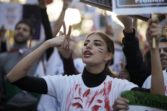 A woman shouts during a protest against the Iranian regime, in Berlin, Germany, Saturday, Oct. 22, 2022, following the death of Mahsa Amini in the custody of the Islamic republic&#039;s notorious &quo ...