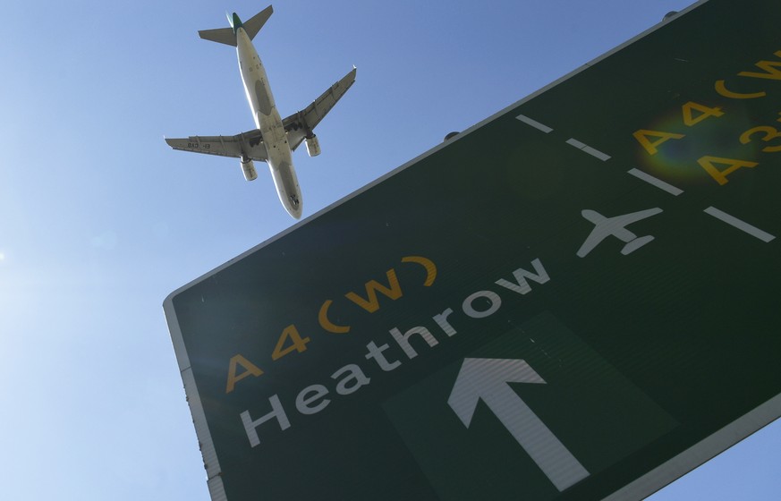 epa06838867 A plane passes a sign as it comes into land at Heathrow Airport in Hounslow, Britain, 25 June 2018. Britain&#039;s Parliament votes on plans to expand the airport with a third runway on 25 ...