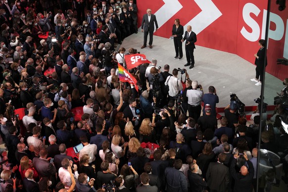 Olaf Scholz, Finance Minister and SPD candidate for Chancellor, center, addresses his supporters after German parliament election at the Social Democratic Party, SPD, headquarters in Berlin, Sunday, S ...