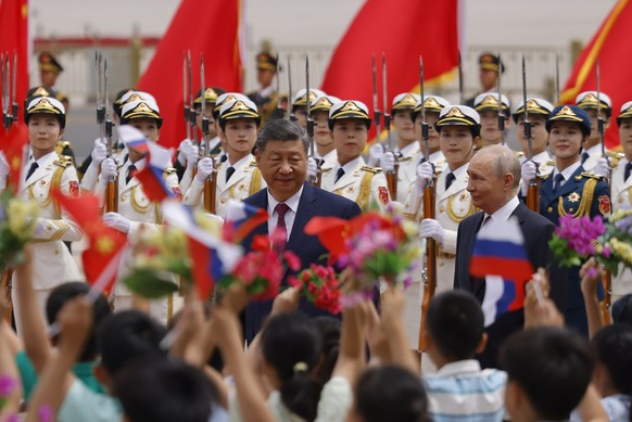 epa12976197 Russian President Vladimir Putin (R) and Chinese President Xi Jinping (L) attend a welcoming ceremony at the Great Hall of the People in Beijing, China, 20 May 2026. EPA/Maxim Shemetov / P ...