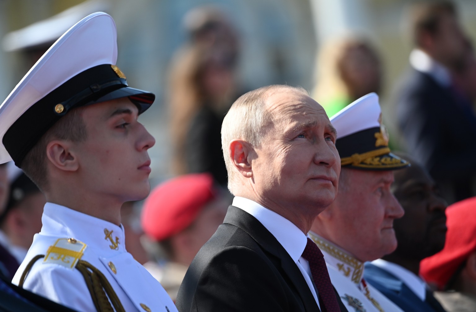 epa10776880 Russian President Vladimir Putin (C) looks on as he attends the Navy Day parade, in St. Petersburg, Russia, 30 July 2023. President Putin announced that the Russian navy will get 30 new sh ...
