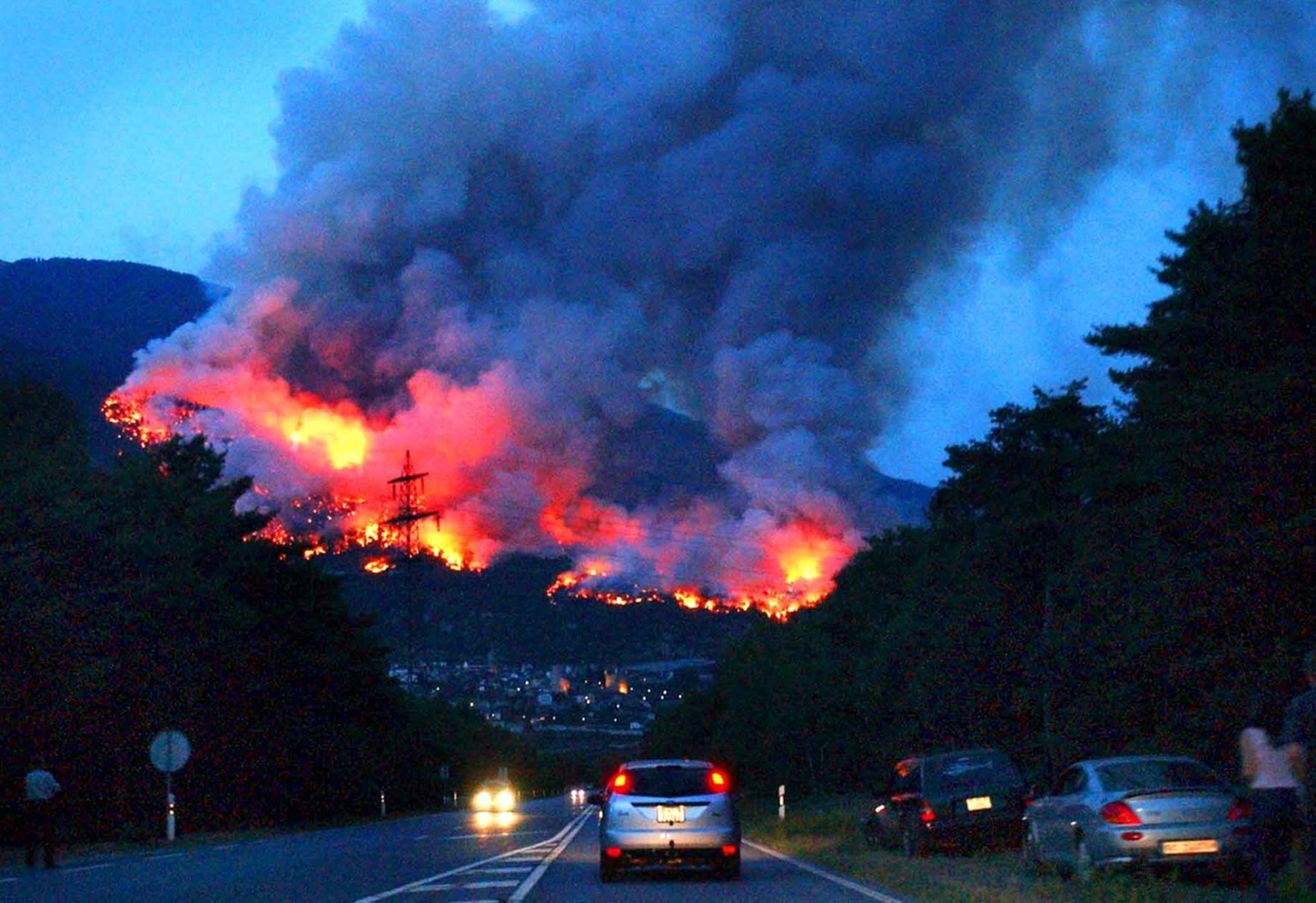 A forest fire that broke out at the border of the village of Leuk, southern Switzerland, early Thursday, August 14, 2003. Due to the drought, several wildfires erupted over the last days in Switzerlan ...