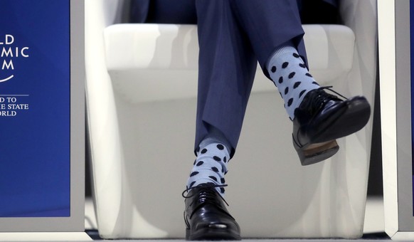 Justin Trudeau, Prime Minister of Canada, wears light blue socks with black dots prior to his special address on corporate responsibility and the role of women in a changing world during the annual me ...