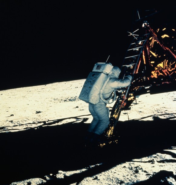 Astronaut Buzz Aldrin descends from the Eagle lunar module onto the surface of the Moon during the Apollo 11 mission. The photograph was taken by mission commander Neil Armstrong with a 70-millimeter  ...