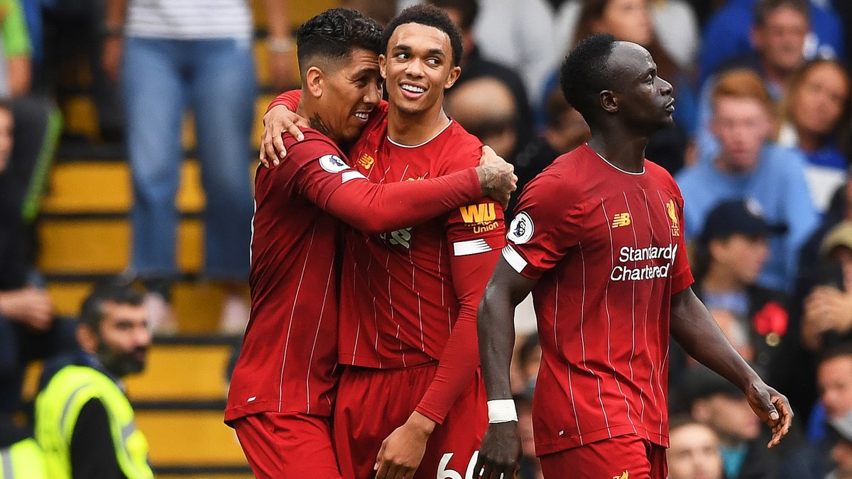 epa07861759 Liverpool's Roberto Firmino (L) celebrates with teammate Trent Alexander-Arnold (C) after scoring the 2-0 lead during the English Premier League soccer match between Chelsea FC and Li ...