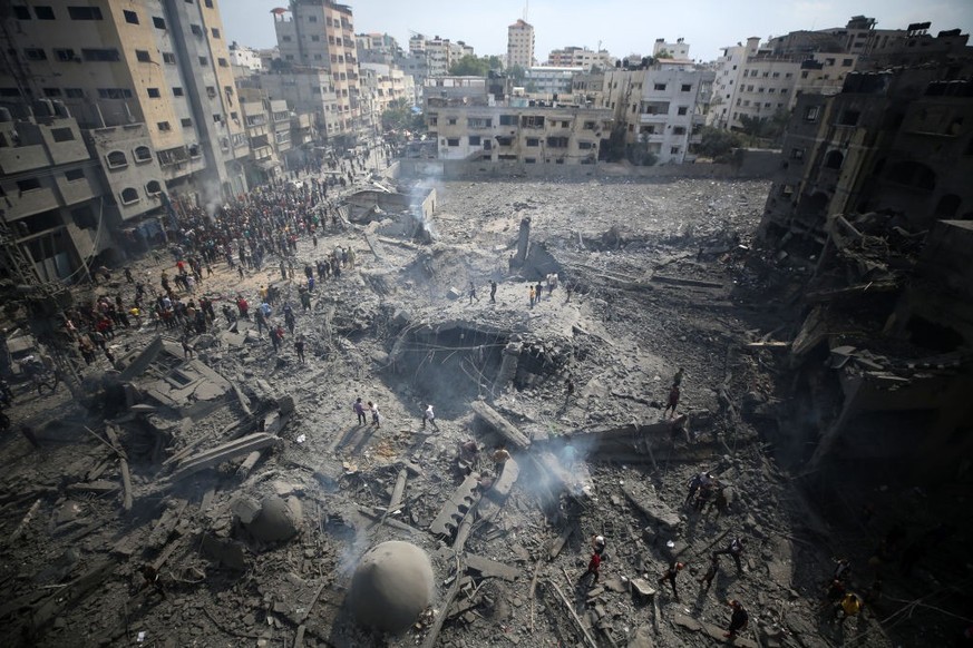 Palestinians inspect damage after an Israeli airstrike on the Sousi Mosque in Gaza City on October 9, 2023. (Photo by Majdi Fathi/NurPhoto via Getty Images)